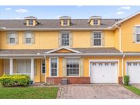 Charming townhome featuring a well-manicured lawn, brick accents and an attached one car garage at 4981 Alita Ter, St Cloud, FL 34769