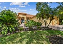 Inviting home with a barrel tile roof, lush landscaping, and brick paver walkway at 517 Milano Rd, Poinciana, FL 34759