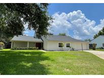 Charming one-story home with well-maintained lawn and a driveway leading to an attached garage at 7200 Green Pine Ct, Orlando, FL 32819
