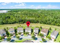 Beautiful aerial view of single-Gathering homes backing to green space and mature trees at 7527 Marker Ave, Kissimmee, FL 34747