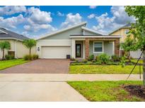 Charming single-Gathering home with a brick driveway and well-maintained landscaping at 8967 Chipping Square Ln, Davenport, FL 33896