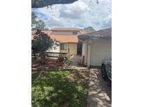 Charming one-story home featuring a well-maintained front yard, a private entrance, and an attached garage at 940 Fenton Ln # 8, Lakeland, FL 33809