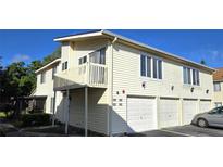 Inviting two-story condo featuring a private balcony and individual garages at 1024 Spring Meadow Dr, Kissimmee, FL 34741