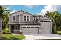 Charming two-story home featuring a three-car garage, stone accents, and lush landscaping at 1038 Wisteria Way, Dundee, FL 33838