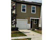 Two story tan home with a one-car garage and a well-kept lawn at 1140 Merrill St, Davenport, FL 33837