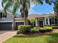 Charming home with a well-manicured lawn and a beautiful palm tree in the front yard at 1771 Lee Janzen Dr, Kissimmee, FL 34744
