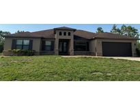 Beautiful one-story home with dark brown shutters and attached two car garage at 18805 Nettleton St, Orlando, FL 32833