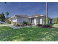 A lovely single-story home boasts a lush green lawn and well-maintained landscaping at 2908 Sunset Lakes Blvd, Kissimmee, FL 34747