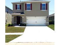 Charming two-story home featuring a spacious two car garage, neutral colors and a well-maintained lawn at 3673 Caspian St, Leesburg, FL 34748