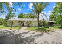Charming single-story home with a neutral exterior, well-maintained landscaping, and a welcoming front entrance at 429 Diamond Acres Rd, Davenport, FL 33837