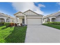 Charming single-story home with a two-car garage, landscaped yard, and covered front porch at 4324 Desert Rose, Kissimmee, FL 34746