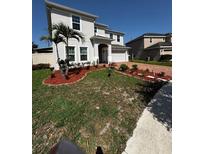 Well-maintained front yard featuring fresh mulch and beautiful landscaping at 4804 Marcos Cir, Kissimmee, FL 34758