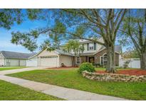 Charming two-story home featuring a well-manicured lawn and a welcoming two-car garage at 483 Stillwater Dr, Oviedo, FL 32765