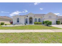 Charming single-story home with a manicured lawn and well-maintained landscaping at 520 Prestwick Dr, Davenport, FL 33897