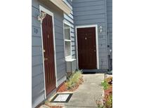 Exterior shot of the unit entrance, with wood-style doors and neutral-colored siding at 709 Orchid Dr, Davenport, FL 33897