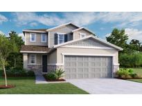 Charming two-story home featuring a two-car garage, stone accents, and a beautifully landscaped front yard at 738 Lake Dell Ave, Dundee, FL 33838