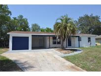 Charming single-story home with a blue garage door and a well-manicured front yard featuring a mature palm tree at 894 Superior St, Deltona, FL 32725