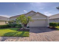 Charming single-story home with well-manicured lawn, lush landscaping, and a two-car garage at 926 Balmoral Dr, Davenport, FL 33896