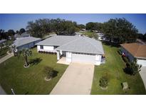 Aerial view of a well-maintained one-story home with a gray roof and green lawn at 10237 Sw 63Rd Ave, Ocala, FL 34476