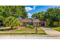 Charming single-story home with a covered carport and landscaped front yard at 1209 Marygon St, Kissimmee, FL 34744