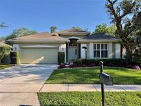 Charming one-story home with a well-manicured lawn, beautiful landscaping and a two-car garage at 1784 Sparkling Water Cir, Ocoee, FL 34761