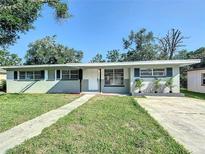 Charming single-story home with a well-manicured lawn and inviting walkway at 220 Hillside Dr, Lakeland, FL 33803