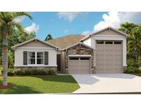 Charming single-Gathering home featuring stone accents and a two-car garage at 3723 Malad Way, Tavares, FL 32778