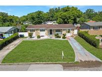 Charming single story home featuring a well manicured lawn and stone accents at 4218 Drexel Ave, Orlando, FL 32808