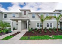 Charming two-story townhouse with a well-maintained lawn and landscaping at 4832 Dedication St, Kissimmee, FL 34746