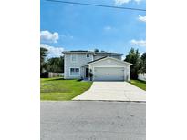 Charming two-story home with a well-manicured lawn and a two-car garage, located on a sunny street at 467 Martigues Drive, Kissimmee, FL 34759