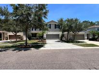 Charming two-story home with neutral colors, two car garage, well-maintained landscaping and a cozy neighborhood at 1043 Tourmaline Dr, Kissimmee, FL 34746