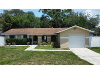Charming single-Gathering home with an attached one-car garage, arched entryway, and neatly kept landscaping at 114 N Alderwood St, Winter Springs, FL 32708