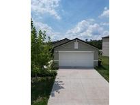 Charming single-story home with a two-car garage and a well-maintained lawn at 2034 Old Pasture Ln, Lakeland, FL 33801