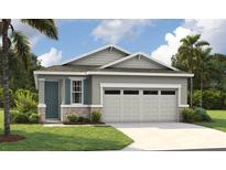 Charming one-story home with stone accents, a two-car garage, and lush landscaping at 231 Bull Frog Ln, Umatilla, FL 32784