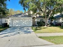 Charming single-story home with a well-manicured lawn and mature trees at 3370 Cypress Point Cir, St Cloud, FL 34772