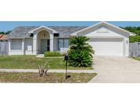 Charming single-story home with a well-maintained front yard, lush landscaping, and attached two-car garage at 408 Sandpiper Ridge Dr, Orlando, FL 32835