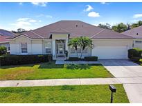 Charming single-story home featuring manicured lawn, attached two-car garage, and lovely landscaping in a desirable location at 426 Prestwick Dr, Davenport, FL 33897