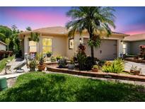 Charming home with a well-manicured lawn, vibrant landscaping, and a welcoming front exterior at 608 Grand Canal Dr, Poinciana, FL 34759