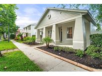 Well-maintained home exterior featuring manicured landscaping and a cozy front porch at 7013 Beargrass Rd, Harmony, FL 34773