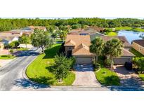 Beautiful single-story home featuring manicured lawns, mature trees, and a brick driveway at 803 Shady Canyon Way, Kissimmee, FL 34759