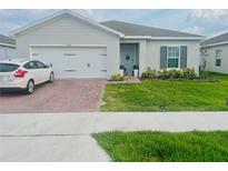 Charming one-story home with a well-maintained front yard and brick paver driveway at 1190 Lexington Lane, Haines City, FL 33844