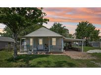 Charming bungalow with a covered porch, carport, and quaint curb appeal at 1626 Gar St, St Cloud, FL 34771