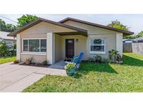 Charming single-story home featuring a cozy front porch, well-maintained lawn, and a welcoming entrance at 1712 Melvin Ave, Orlando, FL 32806
