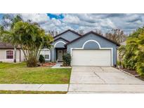 Charming single-Gathering home featuring a two-car garage, mature landscaping, and a welcoming entrance at 2507 Talega Dr, St Cloud, FL 34772