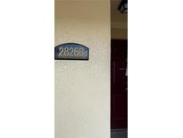 The address sign reads 2826B Cree Tortoise Circle with a deep maroon door at 2826 Club Cortile Cir # B, Kissimmee, FL 34746