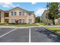 Inviting two-story condo with well-maintained landscaping and ample parking at 2828 Club Cortile Cir # B, Kissimmee, FL 34746