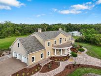 Elegant estate featuring a three-car garage, manicured landscaping, and a welcoming front entrance at 2851 Wagon Ct, St Cloud, FL 34772