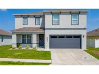 Charming two-story home with a well-manicured lawn and an attached two-car garage at 3053 Royal Tern Dr, Winter Haven, FL 33881