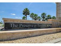 Stone community sign for 'The Preserve at Tapestry' with palm trees, water feature, and blue skies at 3400 Mt Vernon Way, Kissimmee, FL 34741