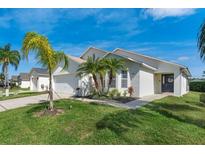 Charming single-story home with a well-manicured lawn, fresh landscaping, and a two car garage at 344 High Point Dr, Davenport, FL 33837